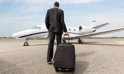A businessman walking towards a private jet