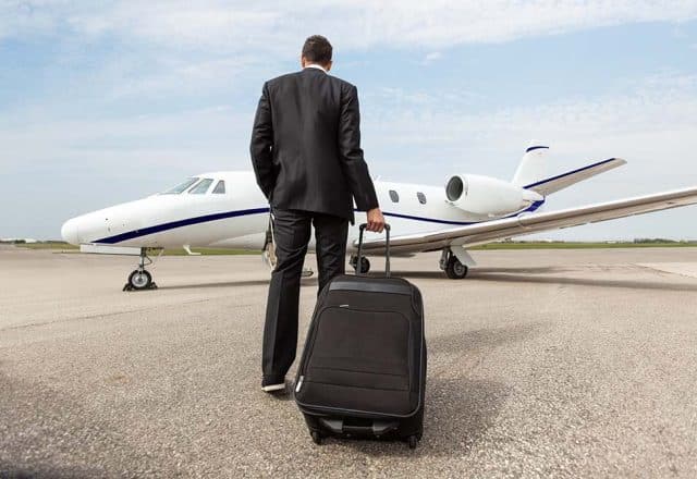 A businessman walking towards a private jet