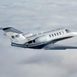 A Cessna Citation soars above the clouds