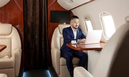 A man working on their laptop on a private jet