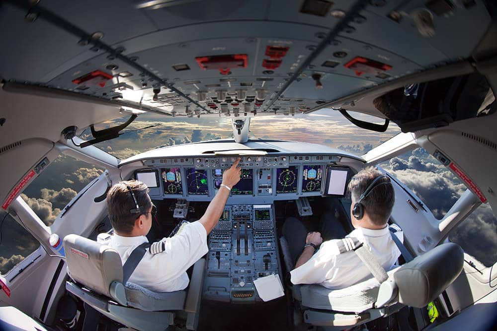 Pilots working in the cockpit of a passenger plane