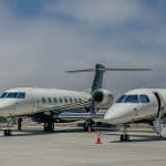 Two private jets on a tarmac