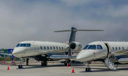 Two private jets on a tarmac