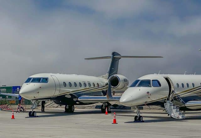 Two private jets on a tarmac