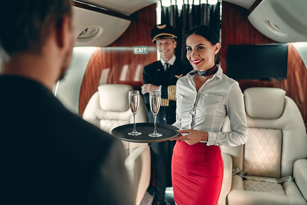 A private jet crew greeting a passenger