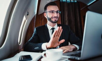 A man on a virtual call on a private jet