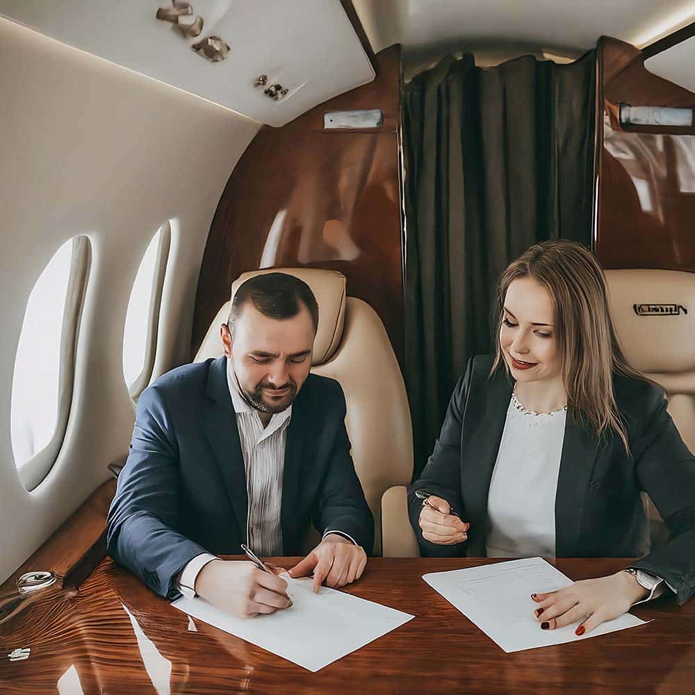 People filling out paperwork in a private jet