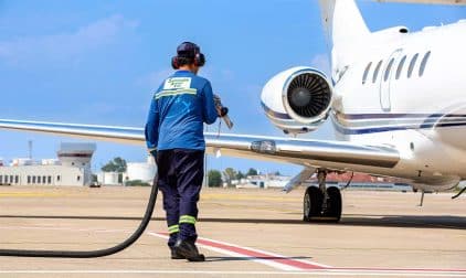 A technician refueling private jet