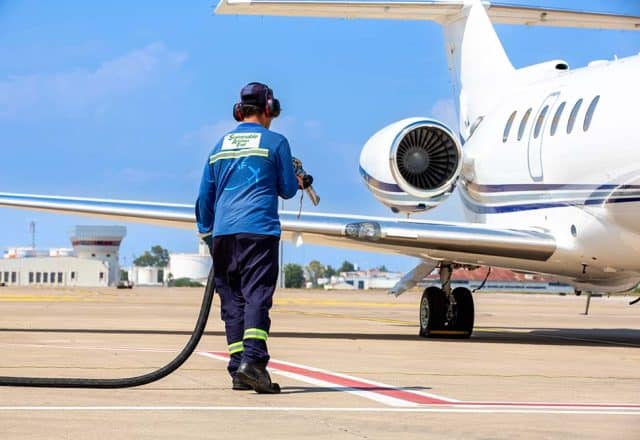 A technician refueling private jet