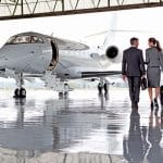 Businesspeople walking towards a private jet