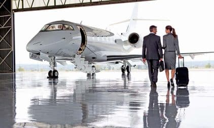 Businesspeople walking towards a private jet