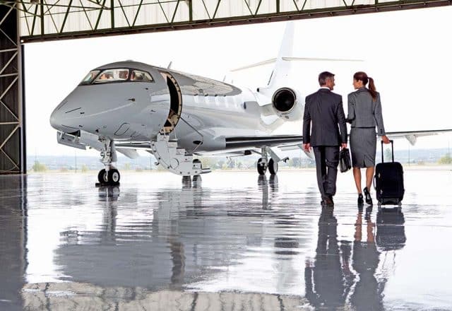 Businesspeople walking towards a private jet