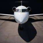 A close-up view of a private jet emerging from its hangar.