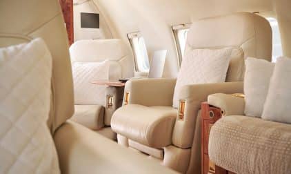 An interior view of a luxurious private jet cabin.